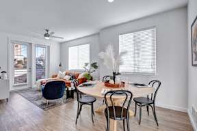 A dining room with a table set for four.