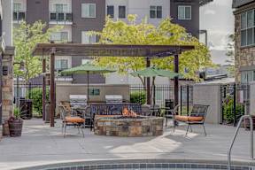 A patio with a fire pit and seating area.