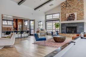 A living room with a fireplace and a pool table.