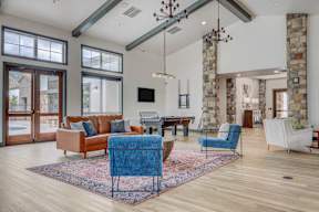 A living room with a blue chair in the middle of the room.