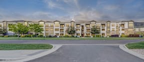 A large apartment complex with a grassy area in front.