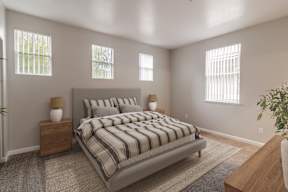 A bedroom with a large bed and two windows.