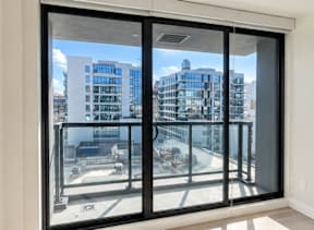 A view of a cityscape through a sliding glass door.