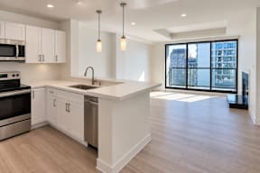 A modern kitchen with white cabinets and a large island.