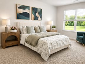 A bedroom with a large bed and two lamps.