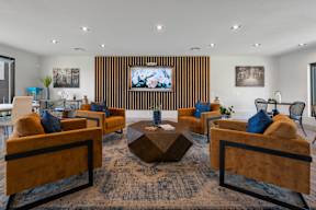 Clubhouse lounge area with velvet chairs at Station 21 apartments in Mesa, AZ.