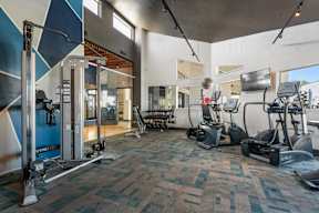 Fitness center with machines and free weights at Station 21 apartments in Mesa, AZ.