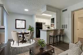 A modern kitchen with a dining table and chairs.