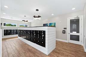 A modern kitchen with a white counter and black cabinets.