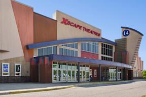 The XScape Theatres building has a red and blue awning.