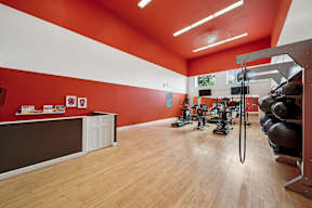 A gym with a variety of equipment and a white counter.