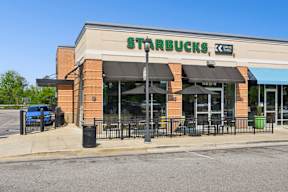 A Starbucks sign is on the front of a building.