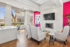 A living room with white furniture and a fireplace.