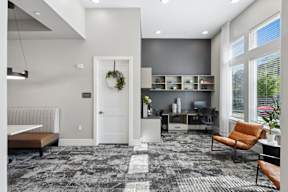 A modern living room with a grey carpet and a white door.