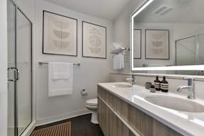 A bathroom with a white sink and a towel hanging on the wall.