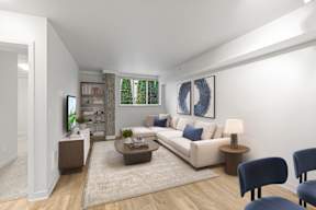 A living room with a white couch, a coffee table, and a blue chair.