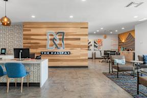 A reception area with a wooden wall and a sign that says "The Halifax".