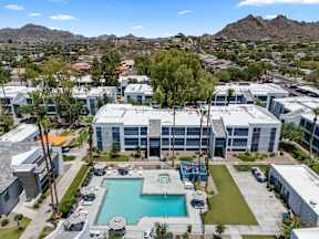 A large building with a pool in front of it.