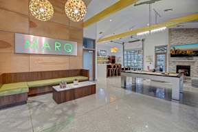 A modern lobby with a bench and a sign that says MARQ.