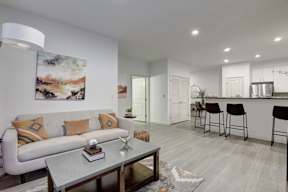 A modern living room with a grey sofa and a grey coffee table.