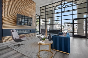 A Clubhouse with a large window and lounge seating, tv mounted, fireplace