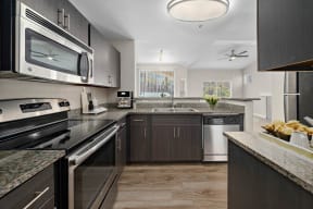 a kitchen with stainless steel appliances and granite counter tops