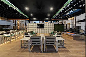 A patio area with tables and chairs is set up for outdoor dining.