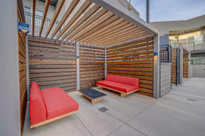 a lounge area with two couches and a coffee table in front of a building
