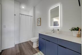 A bathroom with a white toilet and a white sink.