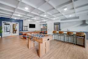 A game table with chairs is in the middle of a room.