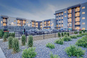 A modern building with a parking lot in front of it.