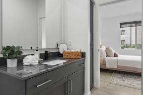 A kitchen with a sink and a mirror.