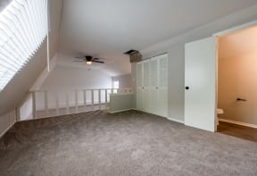 the upstairs bedroom has a closet and a ceiling fan