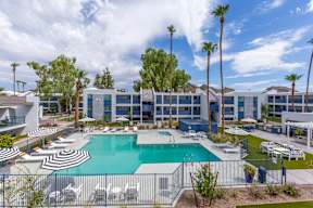 A pool surrounded by a fence with the word hotel written on it.