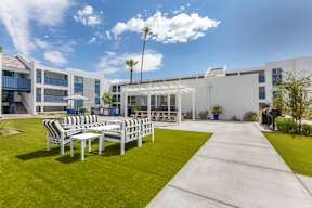 A sunny day at the outdoor seating area of a modern building.