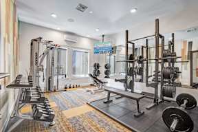 A well-equipped gym with a variety of weightlifting equipment.