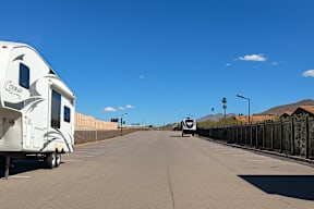 A white RV is parked on the side of a road.