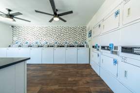 a laundry room with washers and dryers