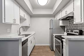 Kitchen with white cabinets and stainless steel appliances at the best apartments in Tempe, AZ.