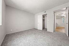 Two-Bedroom Apartments in South Tempe, AZ - Villatree - Bedroom with Spacious Closet, Carpeting, and Natural Lighting