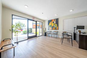 Leasing office with chair and a large window at Villatree apartments in Tempe.