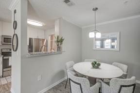 Model home dining area with kitchen overlooking  at Vista Commons Apartments, Columbia, SC