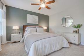 Master bedroom green accent wall ceiling fan  at Vista Commons Apartments, Columbia, 29201