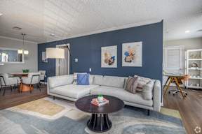 A living room with a grey couch and a coffee table.