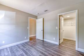 A room with a wooden floor and white walls.