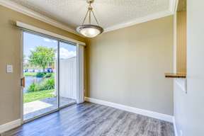 A room with a sliding glass door leading to a patio.