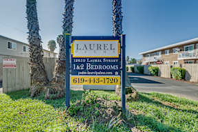 A sign for Laurel Palms with a phone number on it.