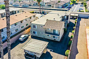 A car is parked in a driveway in front of a house.