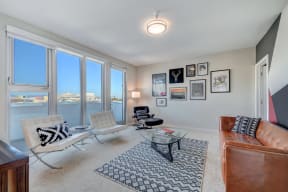 a living room with large windows and a leather couch at L Seven, California