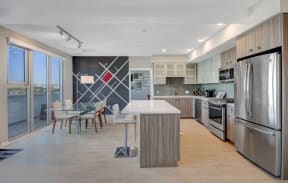 a kitchen with stainless steel appliances and a table with chairs at L Seven, San Francisco